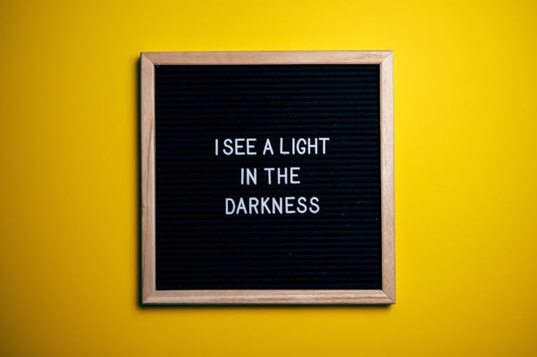 Black letterboard with a motivational quote on a vibrant yellow background.